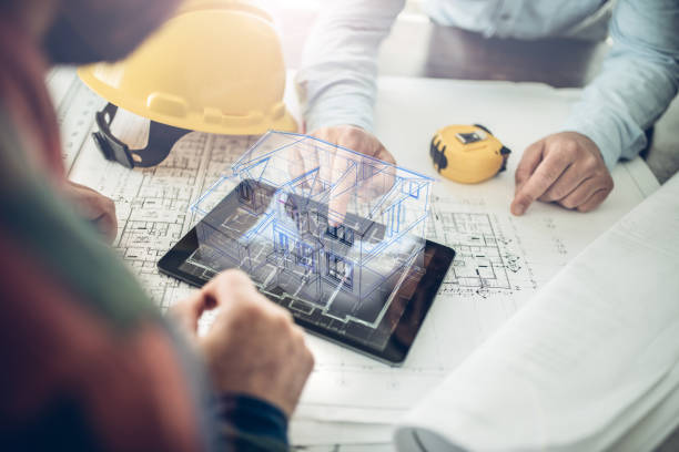 gettyimages-1351472483-612x612 Architect and his client looking at the hologram of a house project over a tablet computer. The client is reviewing his future house layout
Note to inspector: I am the author of the building project