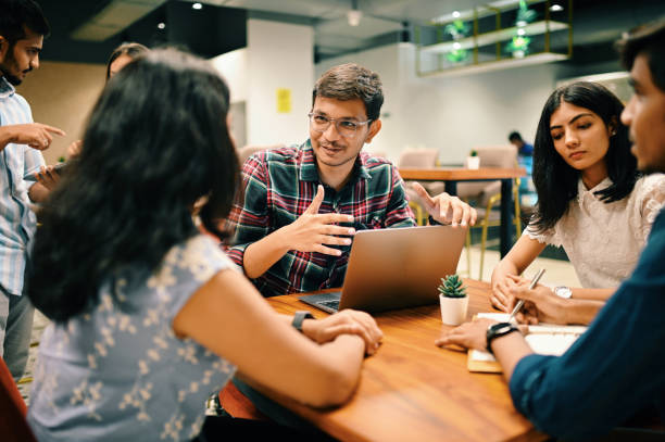 Group of young people discussing new venture  set up in the co-working office