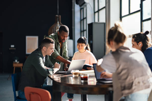 gettyimages-2094337676-612x612 Young professionals or students collaborating in a bright, contemporary co-working environment, displaying teamwork and productivity.