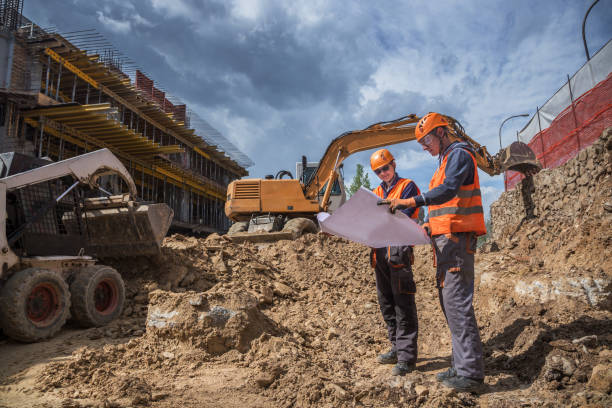Engineers checking project status at a construction site Engineers checking project status at a construction site
